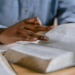Woman in chambray shirt reading Bible