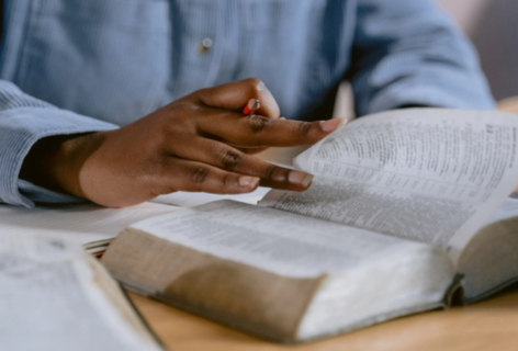 Woman in chambray shirt reading Bible