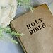 Bible next to white flowers