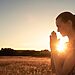 Woman praying to God as sun rises