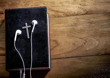 Bible with headphones illustrate worship to jumpstart prayer