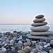 stack of rocks by body of water as analogy for strengthening faith