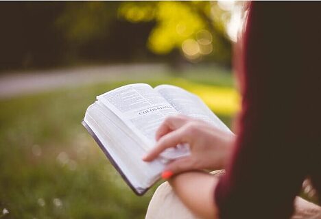 Woman outside reading Bible