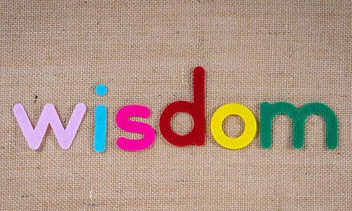 Word “wisdom” spelled out in colorful felt letters illustrate wise word from God