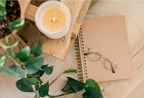 Journal next to candle and plant to illustrate remembering word from God after receiving word from God