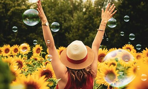Woman with hands lifted represent praising God for being created purposefully