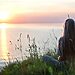 Picture of woman sitting by lakefront as part of hearing God’s voice by cultivating peace