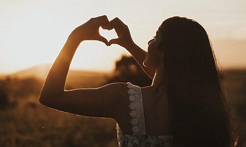 Woman forming heart with her hands illustrate having a heart to hear God