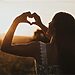 Woman forming heart with her hands illustrate having a heart to hear God