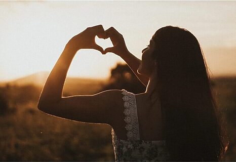 Woman forming heart with her hands illustrate having a heart to hear God