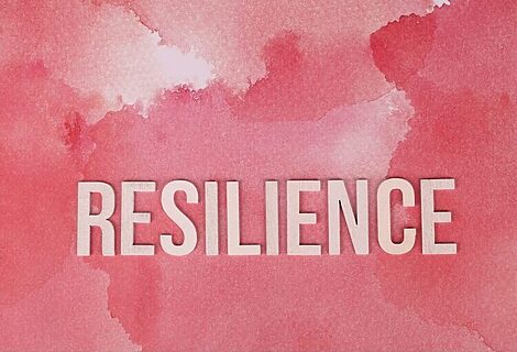 Word resilience on pink background to illustrate building a resilient faith