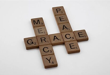 Image of scrabble pieces spelling mercy, grace, and peace