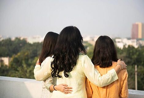 Three women standing together outside arm in arm represents creating an eternal legacy and inspiring others