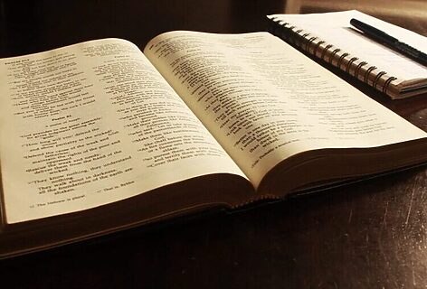 Open Bible next to notebook illustrate studying the Bible for people called by God