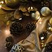 Acorns, gold garland, and Christmas ornaments represent Christmas time
