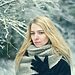 Woman outside on wintry day with scarf and gloves looking gloomy represent Christmas being hard or blue Christmas