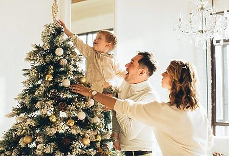 Family putting star on Christmas tree illustrate prioritizing what’s eternal
