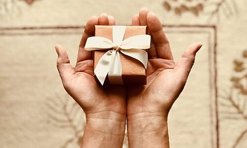 Image of hands holding gift illustrate gratitude
