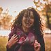 Picture of woman smiling and standing outside illustrates happiness after overcoming doubting God