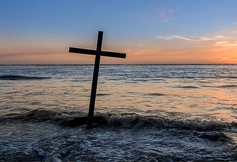 Cross planted near ocean represents God rescuing people
