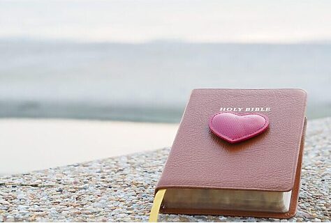 image of Bible with heart on top in outdoor setting represents God’s steadfast love