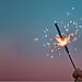Image of hand holding a sparkler illustrates Prayer for God’s Vision in 2025