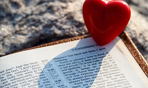 Image of heart next to an open Bible illustrates receiving God’s love