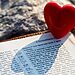 Image of heart next to an open Bible illustrates receiving God’s love