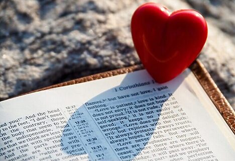 Image of heart next to an open Bible illustrates receiving God’s love