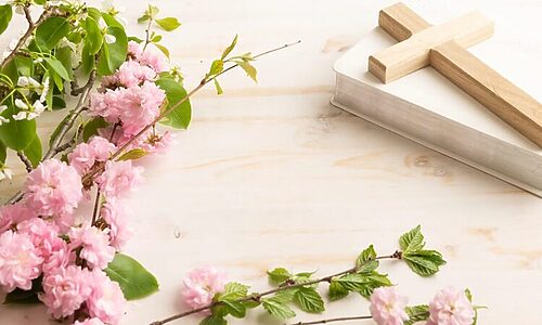 Image of flowers, Bible, and cross illustrate benefits of the cross