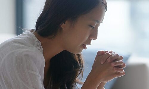 Image of woman praying with folded hands represent strengthening your faith during God’s waiting season